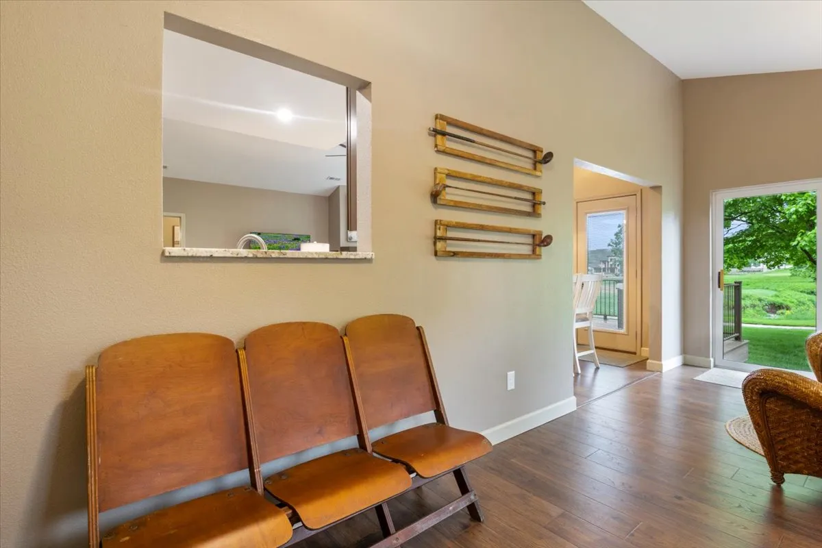 This scene captures wooden seating near an open doorway, with decorative wall racks and glimpses of the outdoors beyond. The openness and arrangement invite guests to step outside, echoing the transition between the comfort of the cottage and the adventures waiting in the nearby state park and along lake paths.